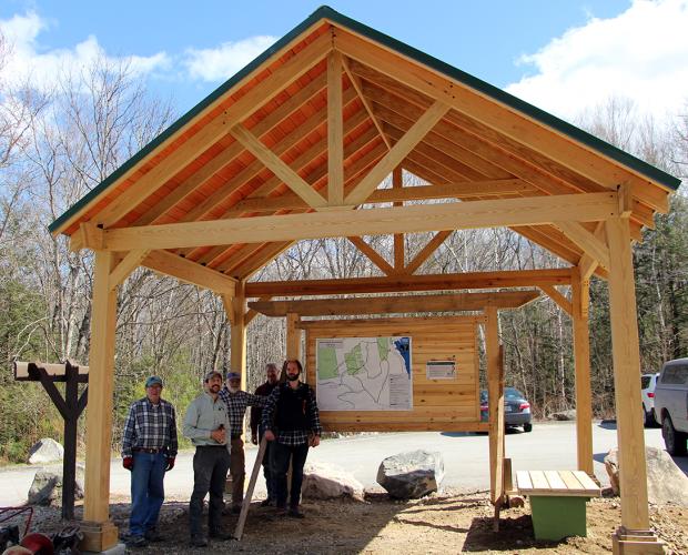 A group of volunteers poses after the completion of the covered pavilion at Mt. Major.