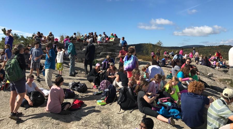 Mount Major summit covered with people during a school hike