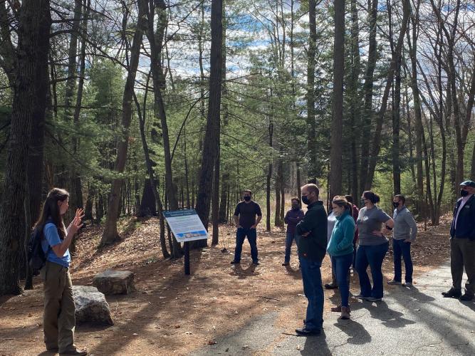 field trip participants masked and distanced stand along Lovewell Pond