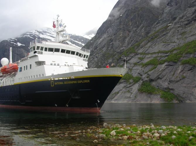 A large boat with National Geographic's logo on the side 