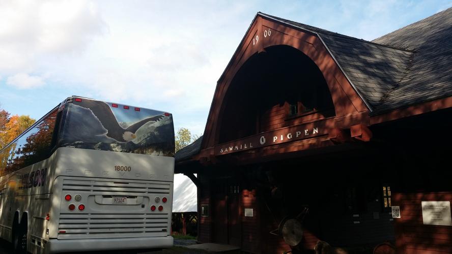 A motorcoach is parked next to the sawmill at The Rocks.